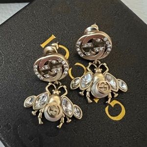 Gucci earrings . Please refer to pictures one diamond missing .